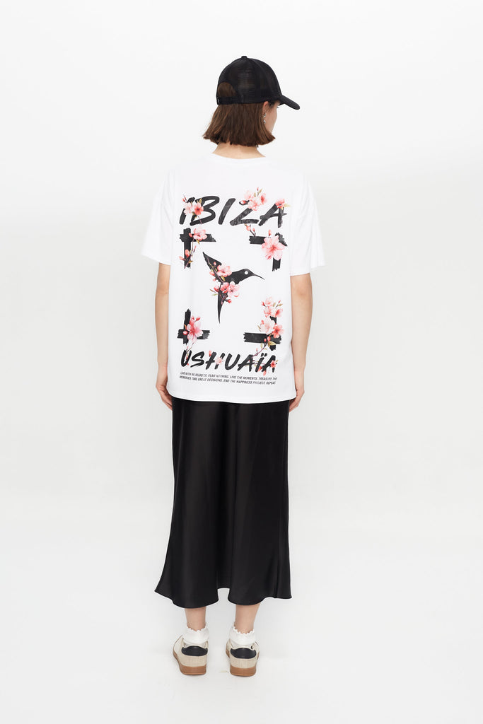 Oversized white T-shirt with bold Ibiza print front & back. Perfect for summer streetwear vibes. Shop the look now!