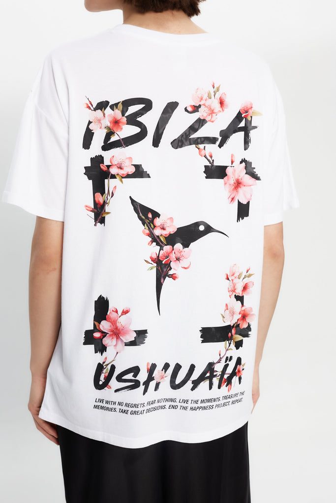 Oversized white T-shirt with bold Ibiza print front & back. Perfect for summer streetwear vibes. Shop the look now!